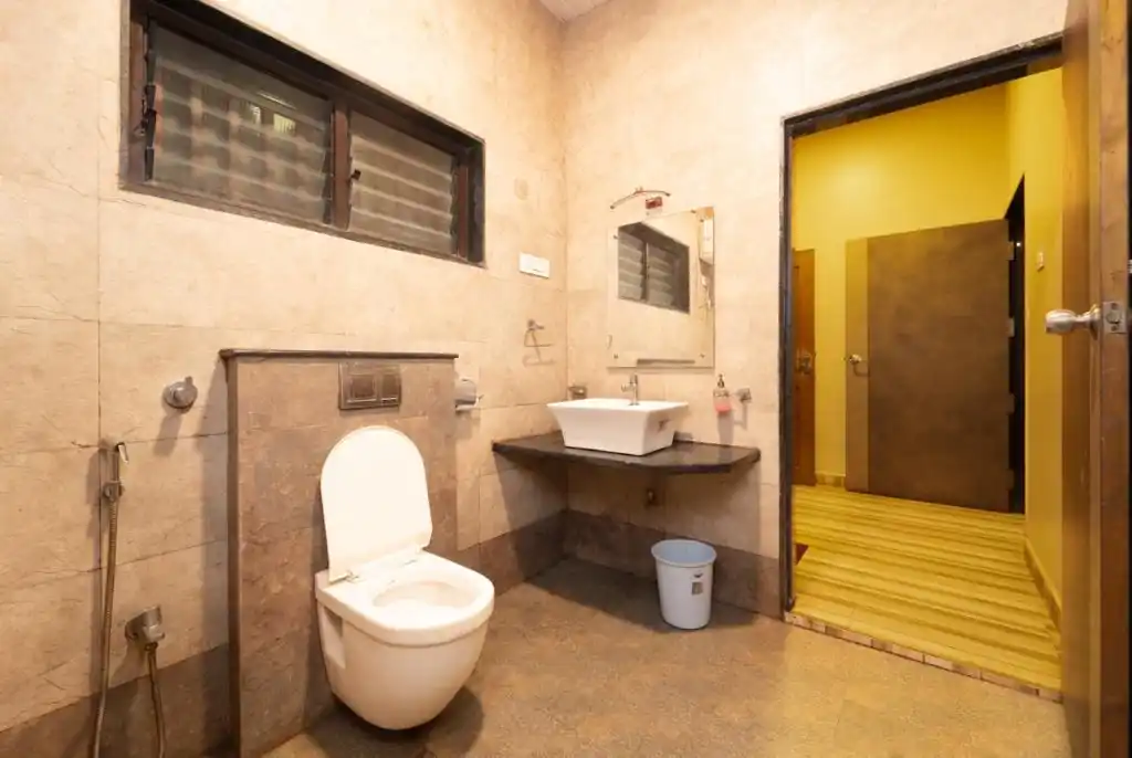 Clean and modern bathroom facilities in AC Deluxe rooms at Dew Drops Resort